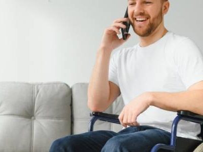 Emergency Respite Care | A disabled man talking on his phone.