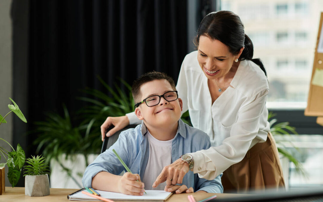 NDIS After School Care : A mother working in an office helps her son with Down syndrome complete an art project.